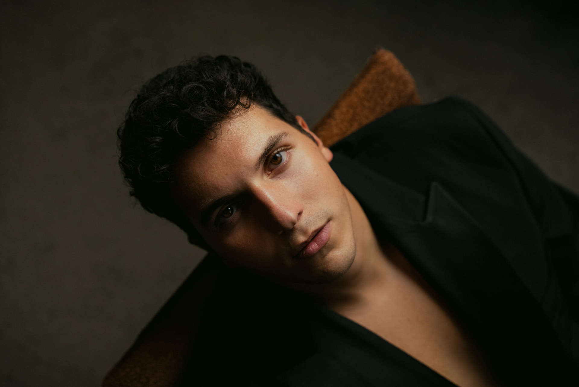 Close-up editorial studio portrait of ILIJA in a black blazer